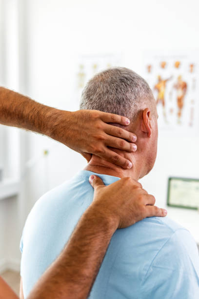 istock Male doctor is examining his neck 1403226738