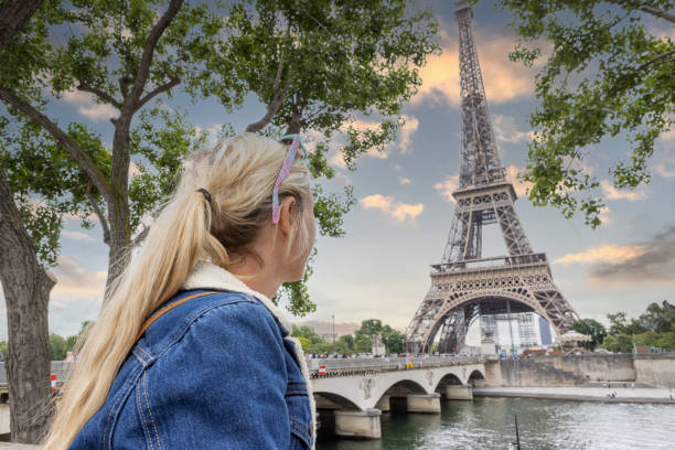 istock Young woman in Paris contemplates the Eiffel Tower 1403227104
