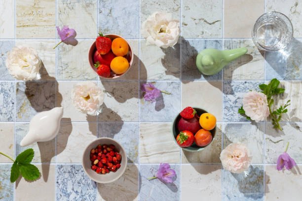 Summer composition with fruits, berries and flowers on the kitchen table. Top view, flat lay.