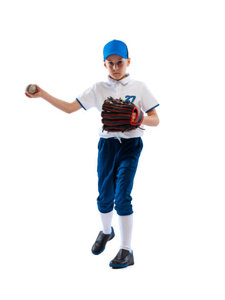 istock Little boy, baseball player, pitcher in blue-white uniform training isolated on white studio background. Concept of sport, achievements, studying, competition. 1403231014