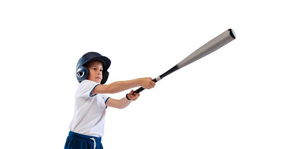 Sportive kid, beginner baseball player in sports uniform with glove and ball isolated on white background. Concept of sport, achievements, competition. School age boy learning to play baseball. Flyer
