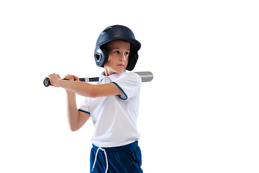 To bat. Little boy, baseball player, pitcher in blue-white uniform training isolated on white studio background. Concept of sport, achievements, studying, competition. Closeup. Copy space for ad