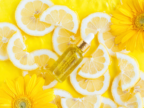 istock Essential oil, serum on textured background with yellow lemon slice 1403233363
