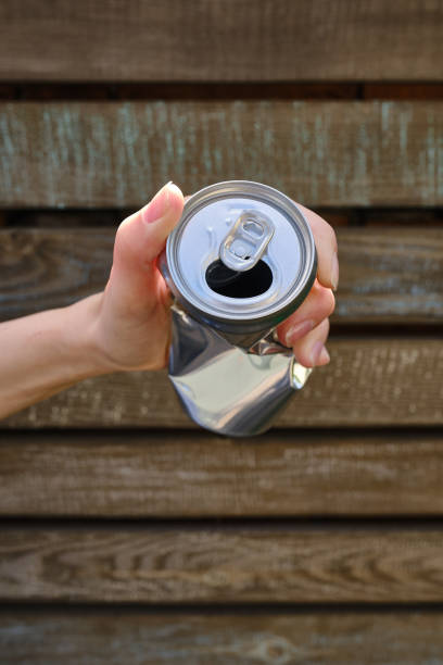 istock Crumpled tin can in hand. Recyclable material. Environmental protection. Zero waste. Used beverage containers 1403238048