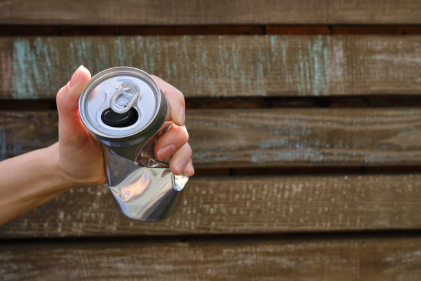 istock Crumpled tin can in hand. Recyclable material. Environmental protection. Zero waste. Used beverage containers 1403238053