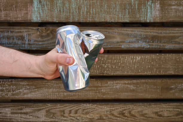 istock Crumpled tin can in hand. Recyclable material. Environmental protection. Zero waste. Used beverage containers 1403238058