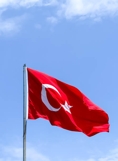 istock turkish flag waving in the air 1403238390