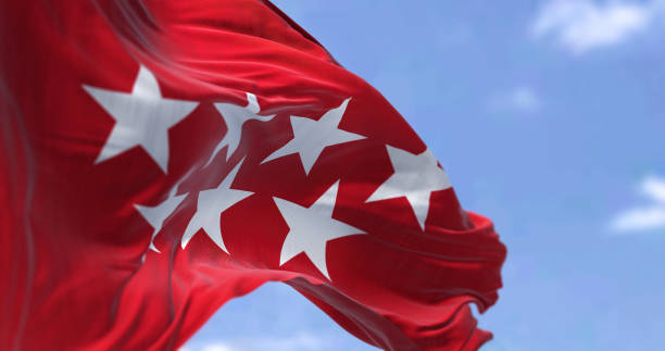 The Community of Madrid flag waving in the wind on a clear day The Community of Madrid flag waving in the wind on a clear day. The Community of Madrid is one of the seventeen autonomous communities of Spain. the flag of the madrid spain stock pictures, royalty-free photos & images
