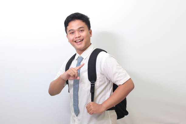 istock high school student showing product, pointing at something and smiling 1403242664