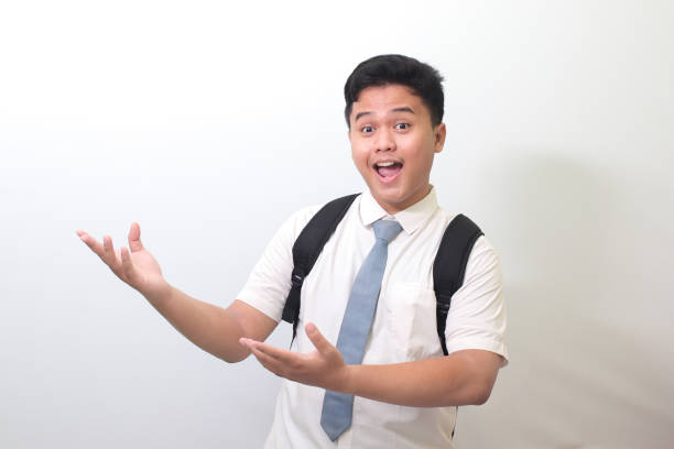 istock high school student showing product, pointing at something and smiling 1403242787