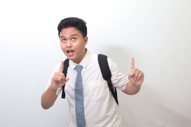 istock senior high school student showing product and pointing up with finger 1403242930