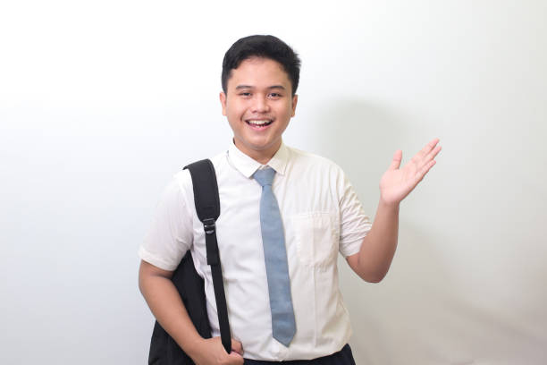 istock high school student showing product, pointing at something and smiling 1403243212