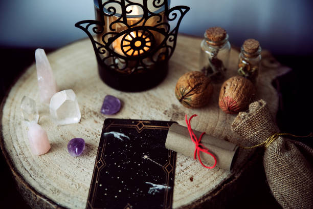 istock Witch altar to perform rituals with crystals, two walnuts, a scroll with a spell and tarot cards. 1403243958