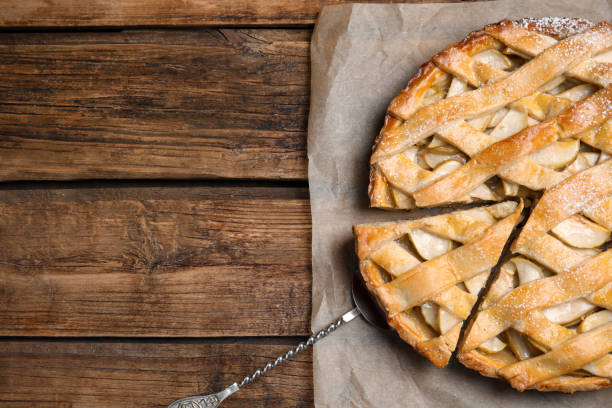 istock Delicious traditional apple pie on wooden table, top view. Space for text 1403245271