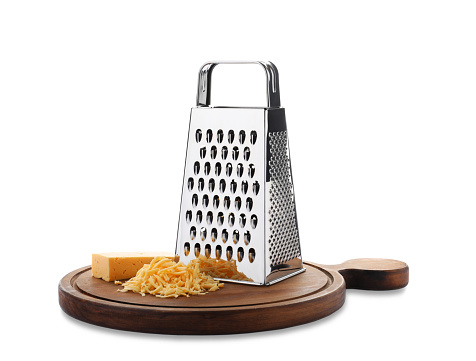 Grater and cheese with wooden board isolated on white