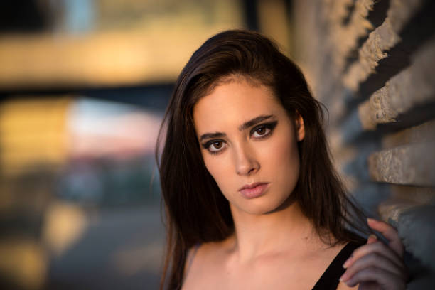 istock Young woman leaning on wall 1403246999