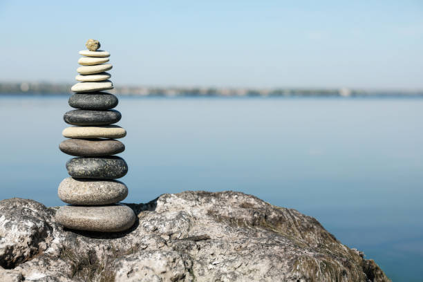 istock Stack of stones on rock near river, space for text. Harmony and balance concept 1403247368