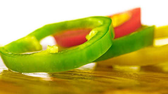 Close-up of bell pepper slices against white background.