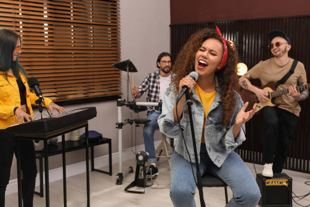 Music band performing in modern recording studio
