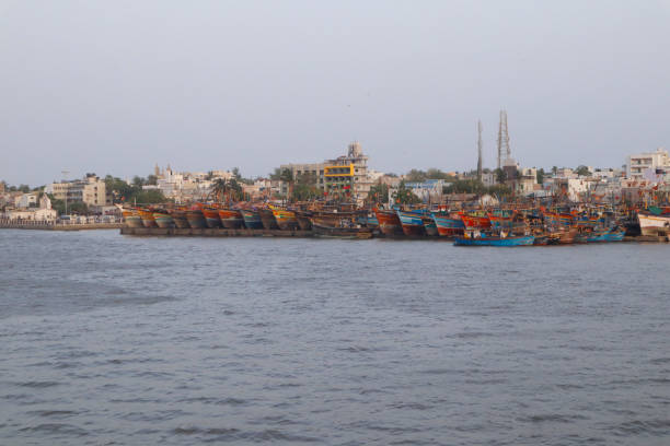 colorful fishing boat on the coast. fishing boats on the shallows and view of the village. sightseeing in diu ghoghla, daman india. the coastline of arabian sea. beautiful landscape. monsoon time. - horizontal landscape coastline gujarat imagens e fotografias de stock