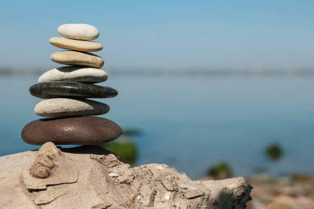 istock Stack of stones on rock near river, space for text. Harmony and balance concept 1403249449