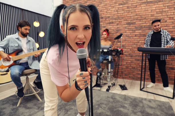 istock Music band performing in modern recording studio 1403250334