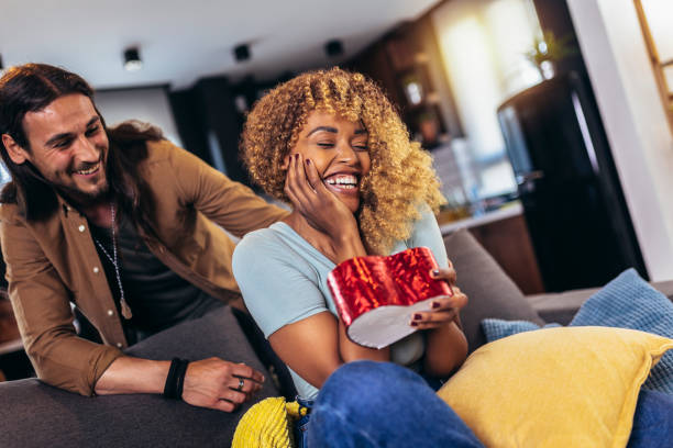 istock Handsome guy giving a gift box to his girlfriend. 1403251155