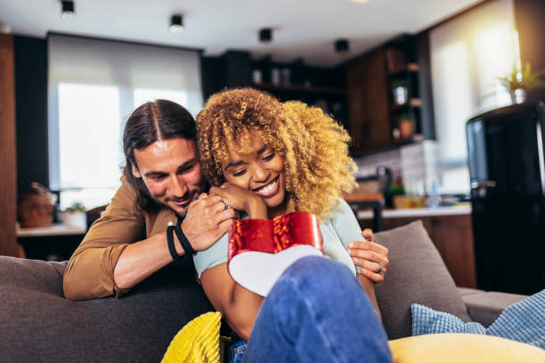 istock Handsome guy giving a gift box to his girlfriend. 1403251160