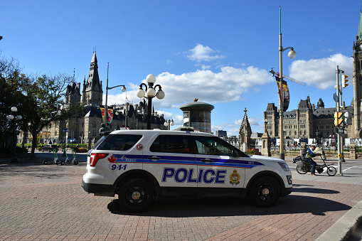People Walking, Canadian Police Land Vehicle Parked In Front Of Parliament Hill Scenery In Ottawa Ontario Canada