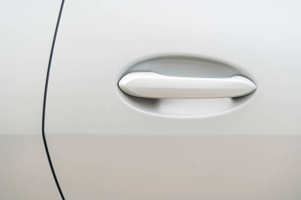 istock Modern door handle of a white car 1403252167