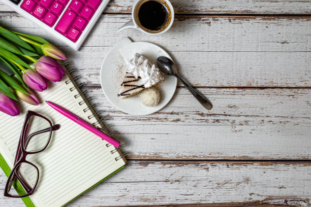 Blank notebook, black coffee cup, Christmas cookies and pen on wood table, Top view and copy space. Xmas, Happy New Year, Goals, Resolution, To do list, Strategy and Plan concept
