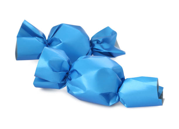istock Delicious candies in light blue wrappers isolated on white 1403253457
