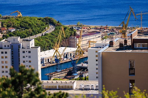 Cranes working on construction site in developing residential area by the sea in Rijeka