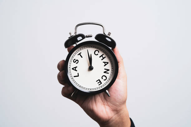 istock Hand holding black alarm clock which inside last chance wording for time and opportunity concept. 1403256673
