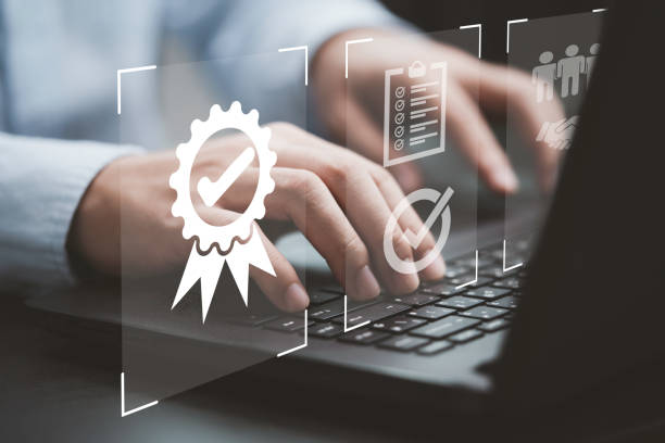 istock Businessman using laptop computer with quality assurance and document icon for ISO or International Standard Organisation which related quality control and continuous improvement concept. 1403256734
