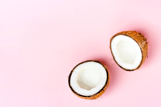 istock Coconut halfs on pastel pink background. Creative summer concept. Food. Copy space 1403256766