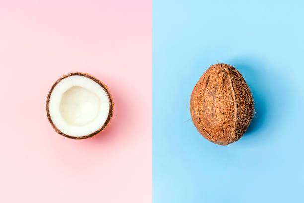istock Coconut whole on blue and half on pink background. Food. Creative layout 1403256769