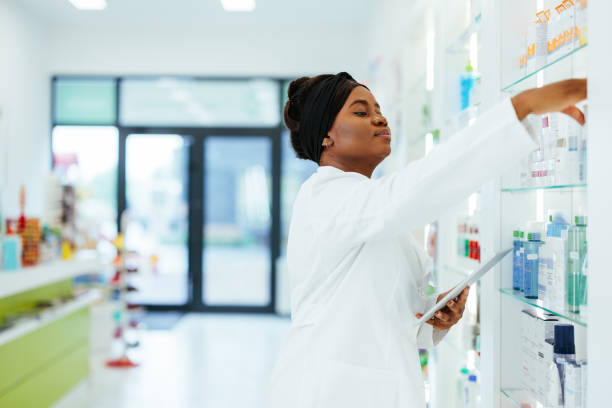 istock Pharmacist doing inventory in a pharmacy with a digital tablet 1403257816