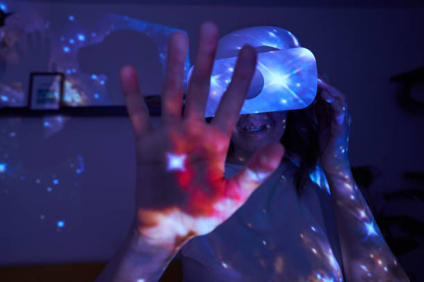 istock Woman is using virtual reality headset. Elements of this image furnished by NASA. 1403257998