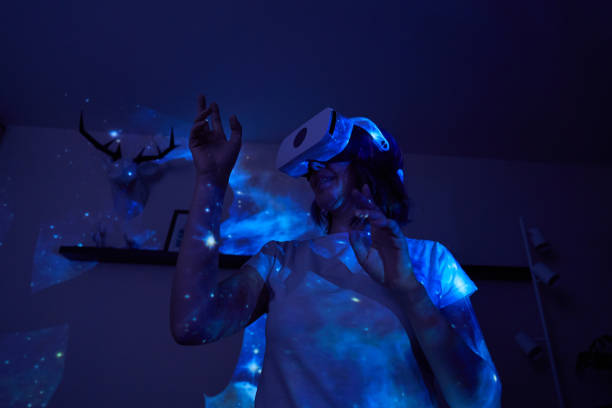 istock Woman is using virtual reality headset. Elements of this image furnished by NASA. 1403258008