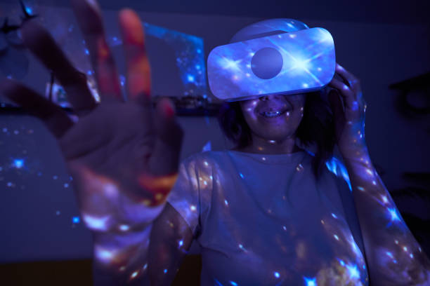 istock Woman is using virtual reality headset. Elements of this image furnished by NASA. 1403258017