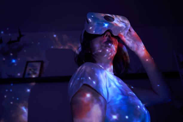 istock Woman is using virtual reality headset. Elements of this image furnished by NASA. 1403258032