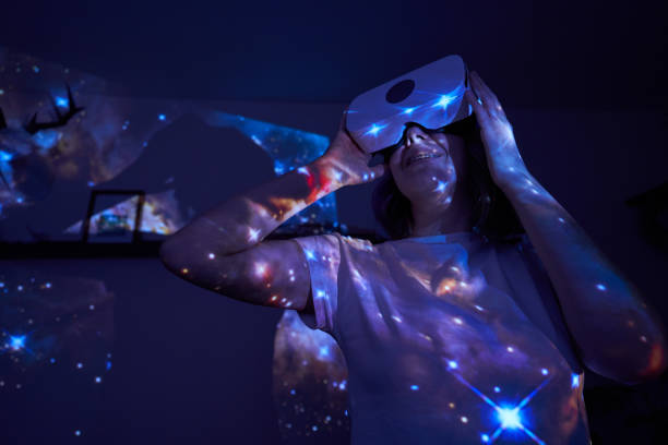 istock Woman is using virtual reality headset. Elements of this image furnished by NASA. 1403258069