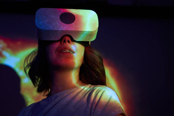 istock Woman is using virtual reality headset. Elements of this image furnished by NASA. 1403258089