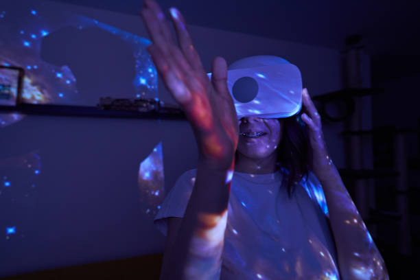 istock Woman is using virtual reality headset. Elements of this image furnished by NASA. 1403258134