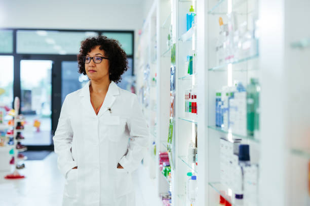 istock Pharmacist standing in pharmacy hands in pockets 1403258199