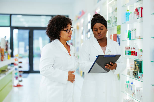 istock Pharmacists reading stock data in pharmacy 1403259022
