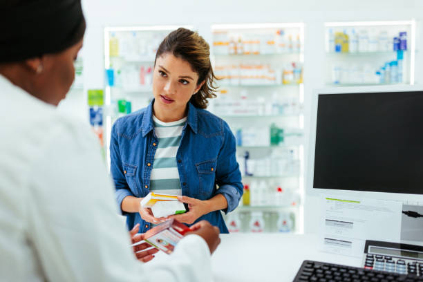 istock Pharmacist explaining use of medication to customer 1403259046