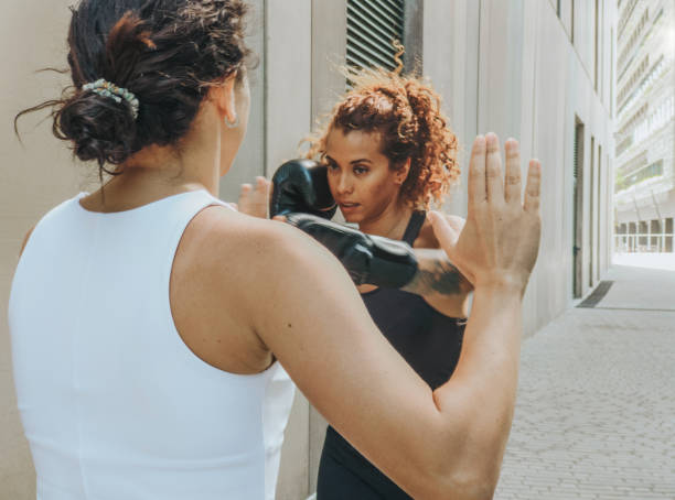 istock Woman training boxing with coach outdoors 1403259115