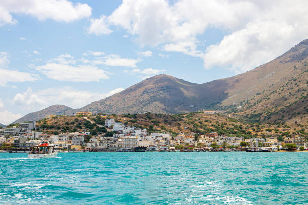 Village of Elounda also known as Elounta or Elouda on island of Crete in Greece, Europe. Seen from sea. 2022 summer. stock photo
